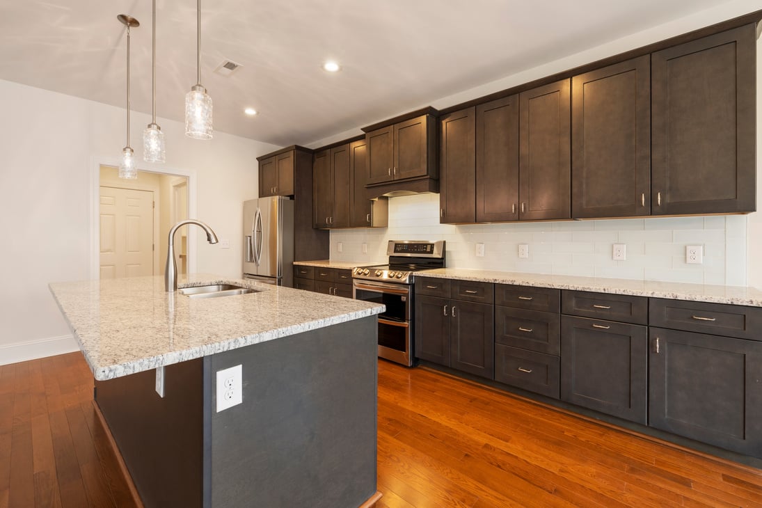 Black Wooden Kitchen Cabinet and White Wall